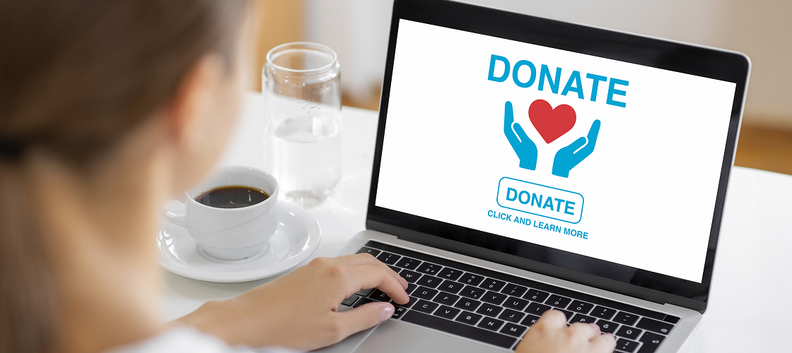 Woman using laptop to donate online