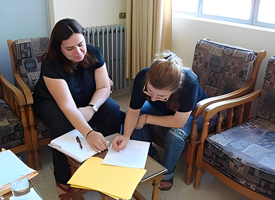 Women collaborating over documents in office