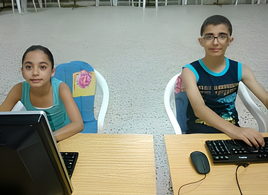 Children using computers at wooden desks
