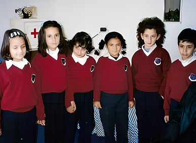 Children in red school uniforms