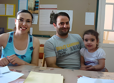 Smiling family sitting together at table