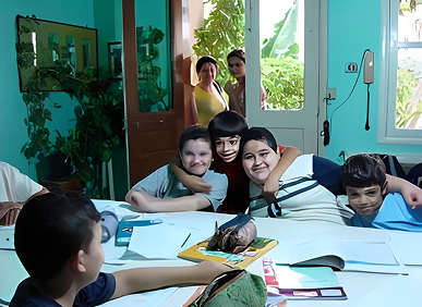 Children smiling around a table