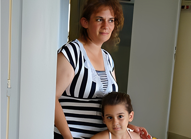 Mother and daughter standing together